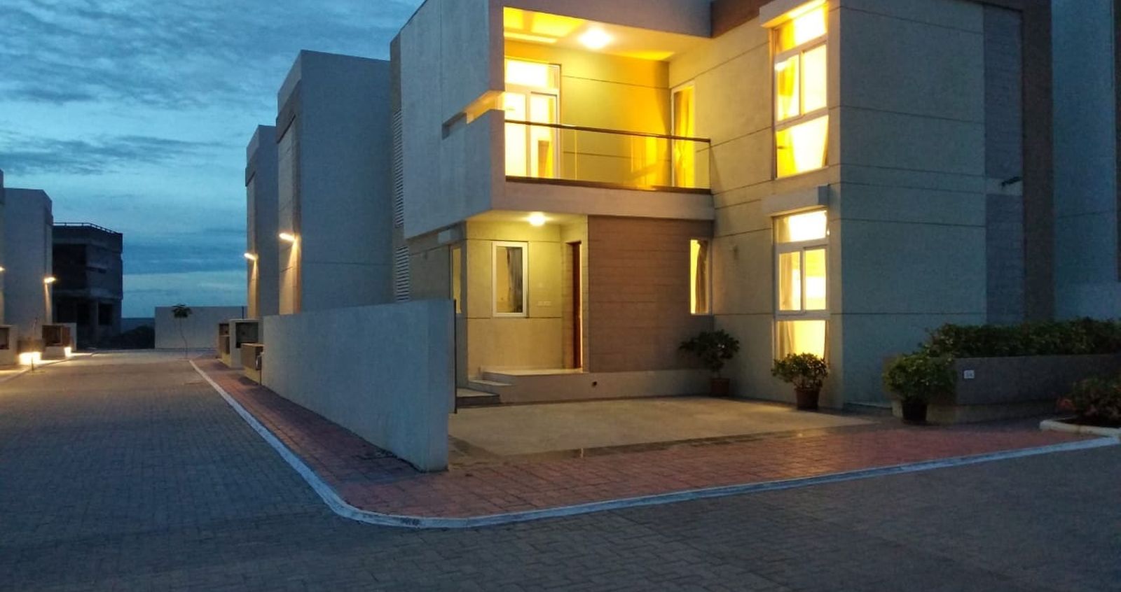 Aurum Villas by Pacifica – a completed earlier-phase villa at dusk (actual photograph; not Phase III)